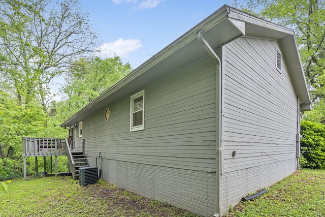 view of home's exterior featuring stairway, a deck, and central AC