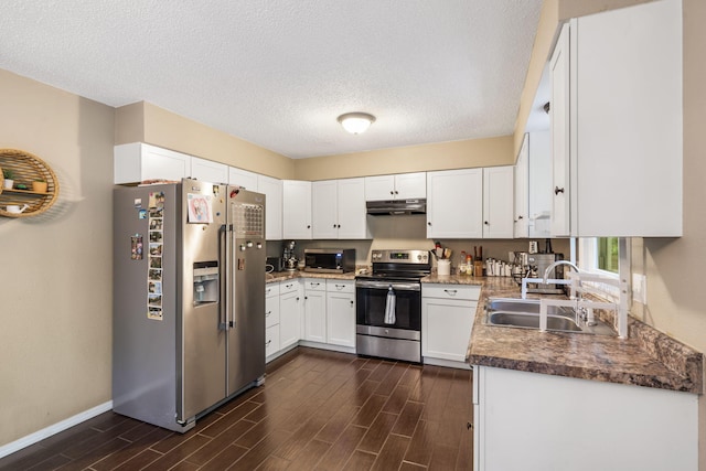 kitchen featuring appliances with stainless steel finishes, dark wood finished floors, a sink, under cabinet range hood, and white cabinetry
