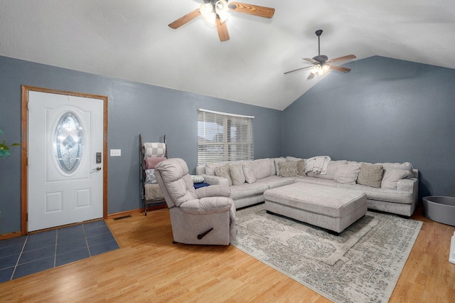 living room with ceiling fan, light wood-style flooring, and lofted ceiling