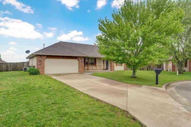 ranch-style home featuring fence, an attached garage, brick siding, a front yard, and concrete driveway