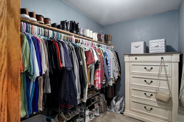 walk in closet featuring carpet floors and lofted ceiling