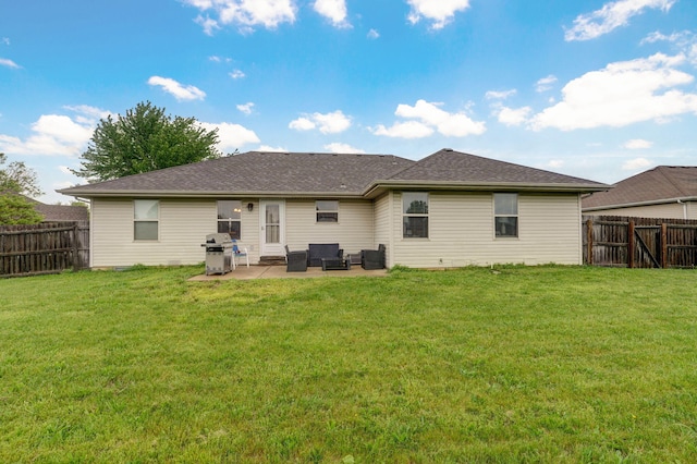 back of house featuring a lawn, a fenced backyard, a patio area, and an outdoor hangout area