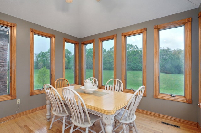 dining area featuring baseboards, visible vents, and wood finished floors