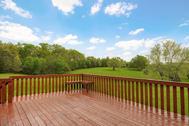 wooden terrace featuring a yard