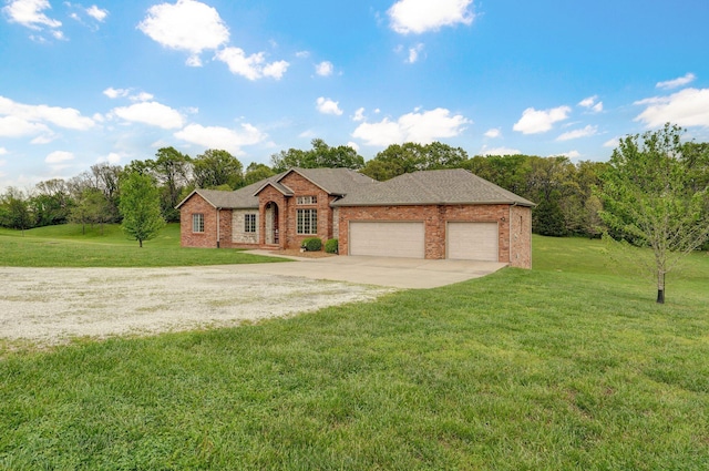 single story home with a garage, concrete driveway, a front lawn, and brick siding