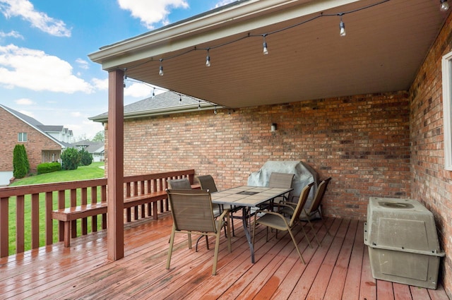 wooden terrace featuring outdoor dining area