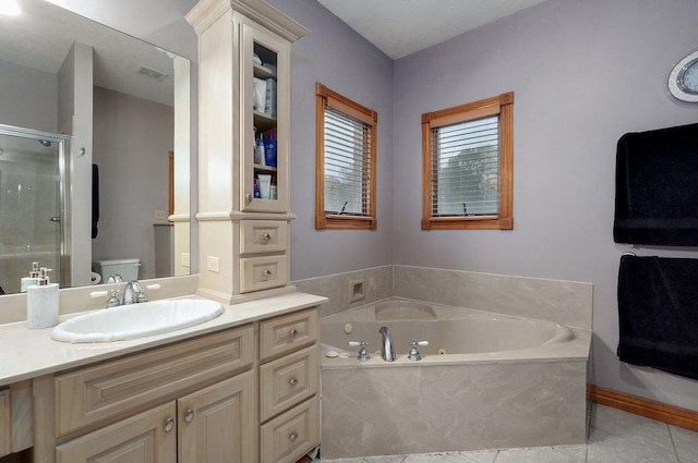 bathroom with vanity, toilet, tile patterned floors, a jetted tub, and a shower stall