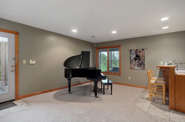 sitting room featuring baseboards, light carpet, and recessed lighting