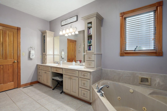 bathroom featuring a sink, tile patterned floors, a tub with jets, and double vanity