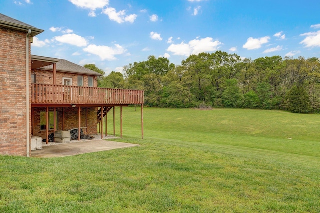 view of yard with a wooden deck and a patio