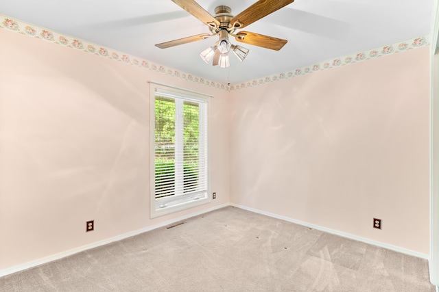 unfurnished room featuring a ceiling fan, baseboards, visible vents, and light carpet