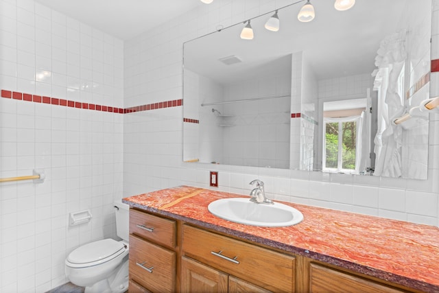 full bath with vanity, backsplash, toilet, and tile walls