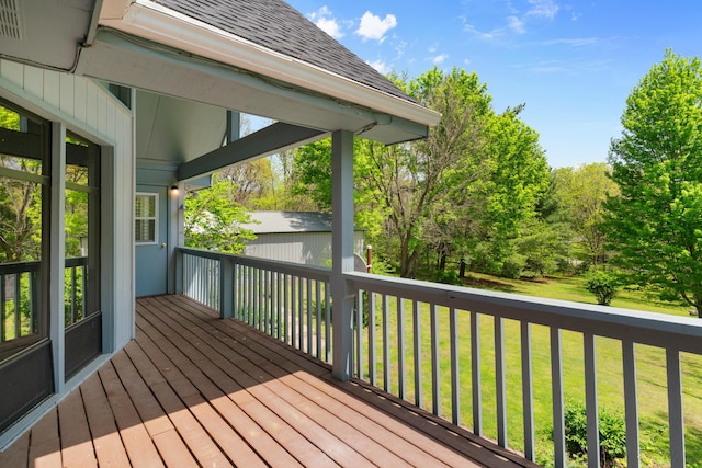 wooden terrace with a lawn