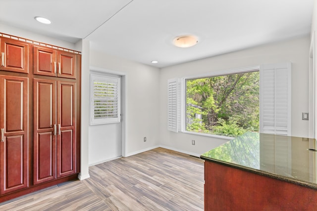interior space with plenty of natural light, recessed lighting, baseboards, and light wood-style floors