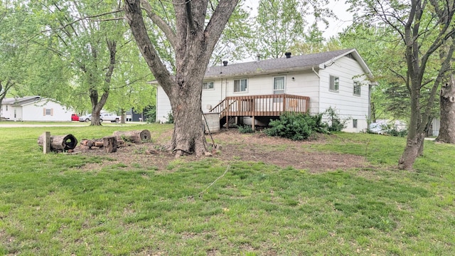 back of house featuring a yard and a deck