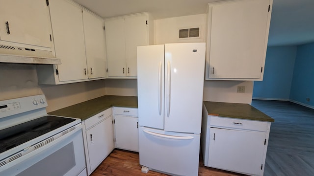 kitchen featuring white cabinets, dark wood-style flooring, dark countertops, white appliances, and under cabinet range hood