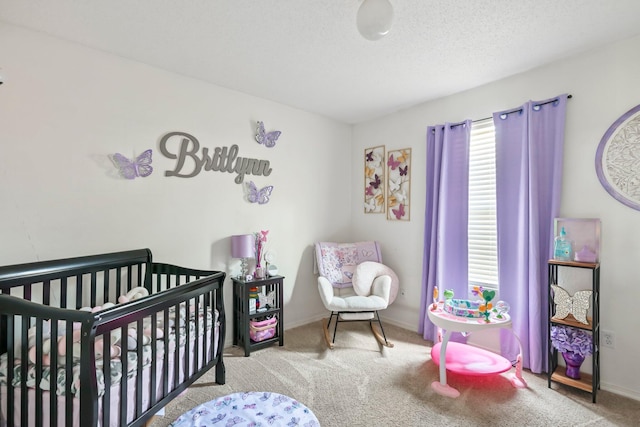 bedroom featuring a nursery area, baseboards, and carpet