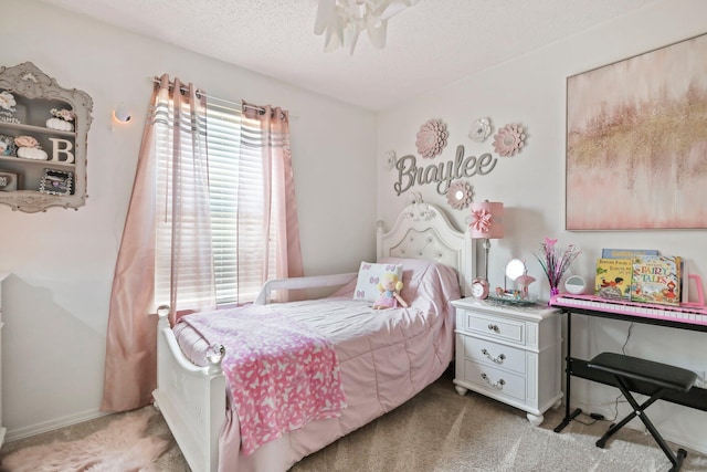bedroom with baseboards, a textured ceiling, and light colored carpet