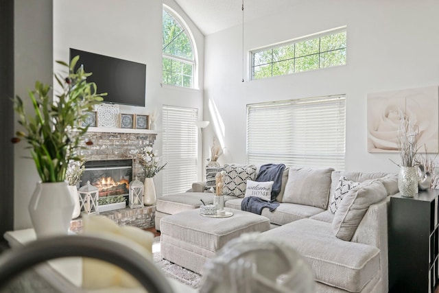 living room with high vaulted ceiling and a brick fireplace