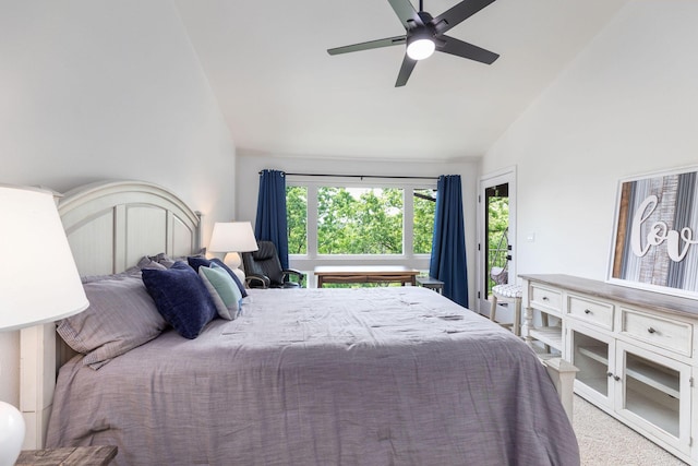 bedroom with a ceiling fan, vaulted ceiling, carpet flooring, and access to exterior