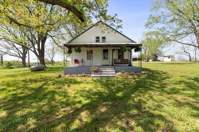 view of front facade featuring covered porch and a front lawn