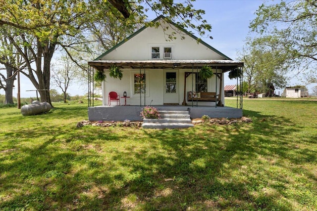 view of front of house with covered porch and a front yard