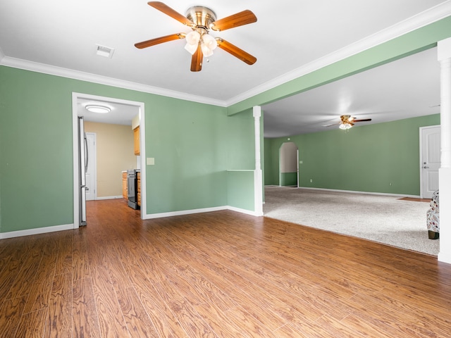 1208 Kemp Dr, Bolivar, MO 65613 - spare room featuring visible vents, ornamental molding, ceiling fan, and arched walkways