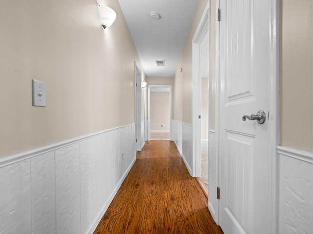 1208 Kemp Dr, Bolivar, MO 65613 - hall featuring visible vents, wainscoting, and wood finished floors
