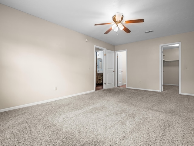 1208 Kemp Dr, Bolivar, MO 65613 - unfurnished bedroom with visible vents, baseboards, carpet floors, and a walk in closet
