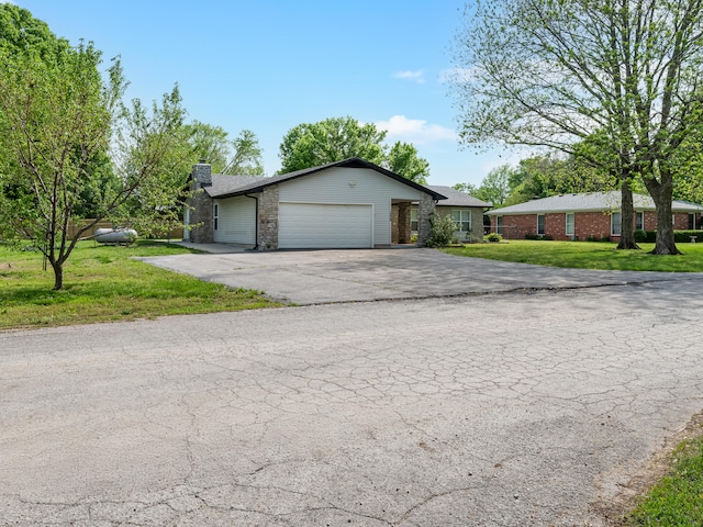 1208 Kemp Dr, Bolivar, MO 65613 - single story home featuring a garage, aphalt driveway, a front yard, and a chimney