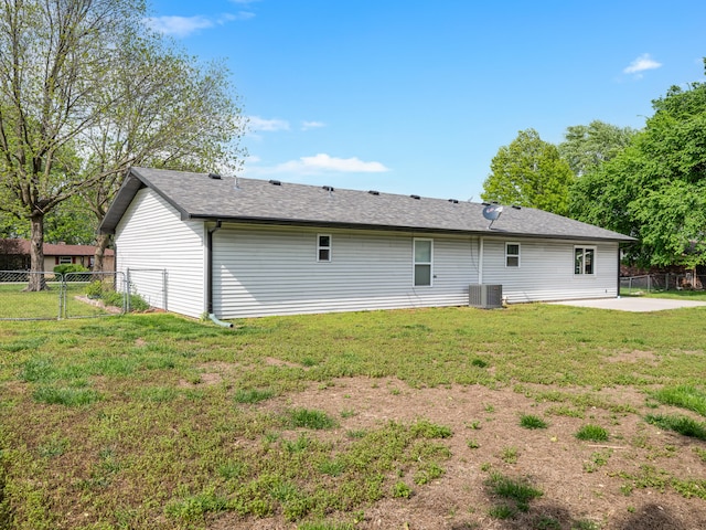 1208 Kemp Dr, Bolivar, MO 65613 - back of house featuring roof with shingles, central AC unit, fence, a yard, and a patio