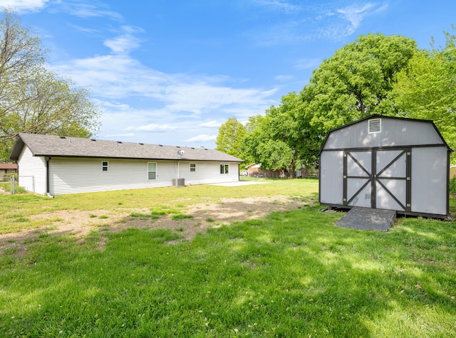 1208 Kemp Dr, Bolivar, MO 65613 - exterior space with a storage unit, central AC unit, a yard, and an outbuilding