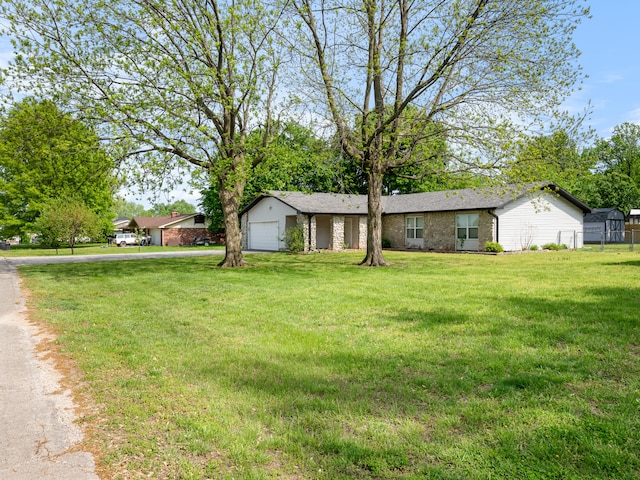 1208 Kemp Dr, Bolivar, MO 65613 - ranch-style house with an attached garage, brick siding, driveway, and a front yard