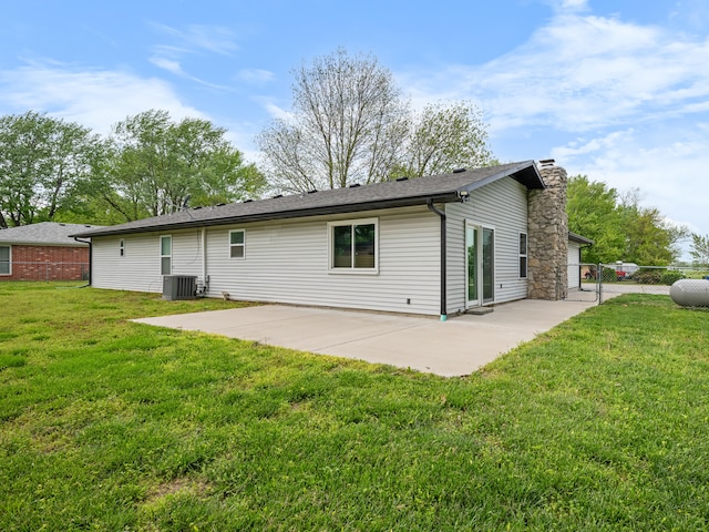 1208 Kemp Dr, Bolivar, MO 65613 - back of property with a chimney, a patio area, fence, cooling unit, and a yard