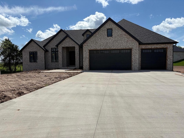 1971 N Alysheba Ct, Springfield, MO 65802 - french provincial home with brick siding, a garage, a shingled roof, and concrete driveway