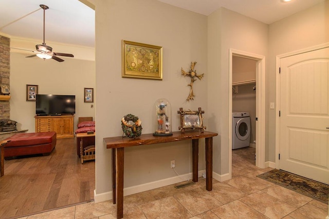 interior space featuring a ceiling fan, washer / dryer, and light tile patterned floors