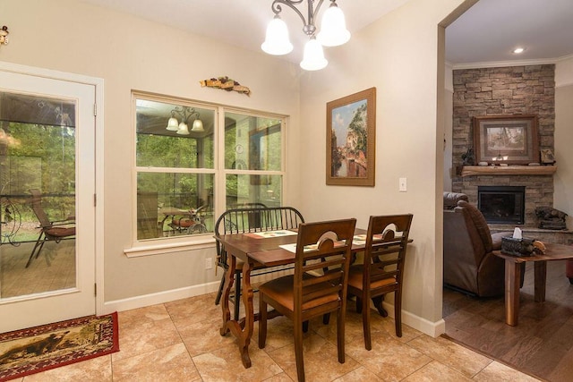 dining space with an inviting chandelier, baseboards, light tile patterned floors, and a fireplace