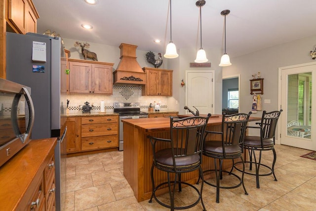 kitchen with decorative backsplash, premium range hood, a center island, electric stove, and wood counters