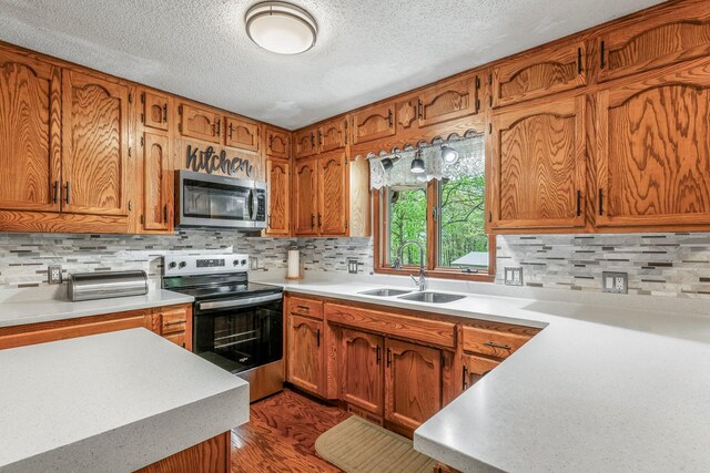 kitchen with a sink, stainless steel appliances, and brown cabinets