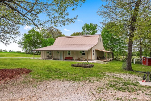 farmhouse inspired home featuring metal roof and a front yard