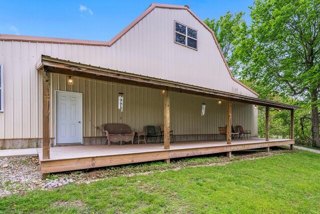back of house with a lawn and a deck