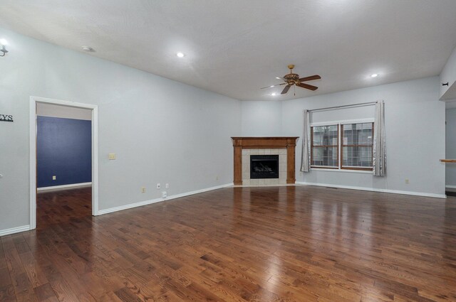 unfurnished living room with recessed lighting, a ceiling fan, wood finished floors, and a tile fireplace