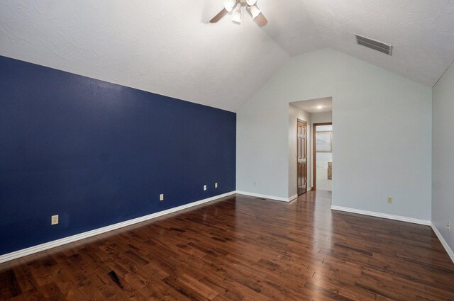 interior space with visible vents, lofted ceiling, wood finished floors, baseboards, and ceiling fan