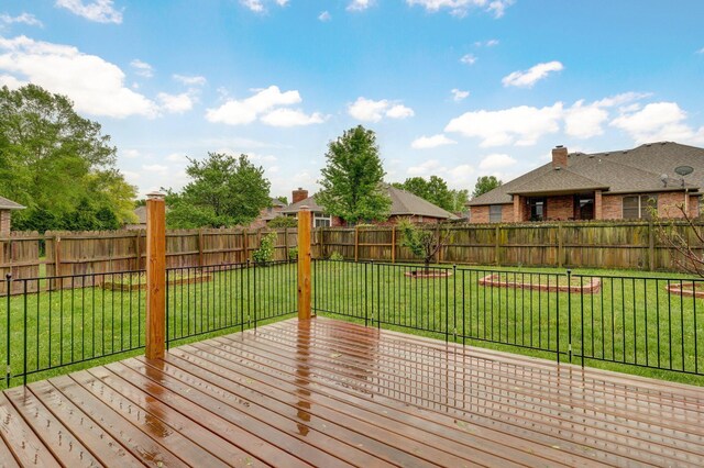 deck with a lawn and a fenced backyard