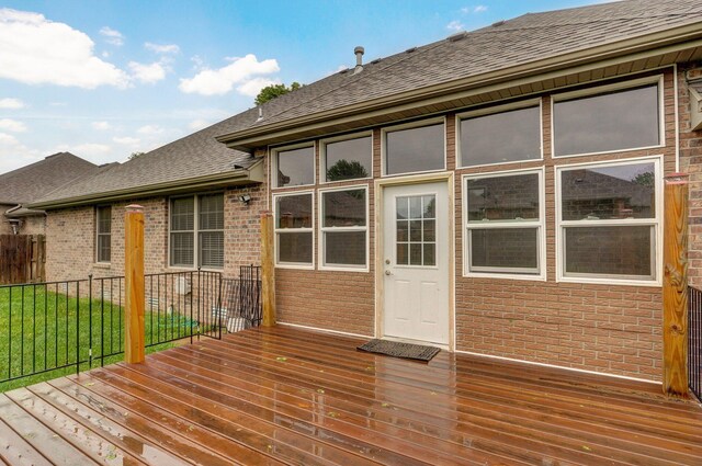 deck featuring fence and a lawn
