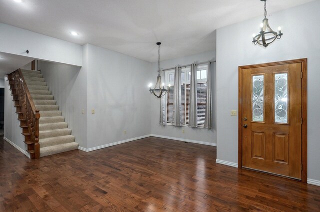 foyer featuring dark wood-style floors and a notable chandelier