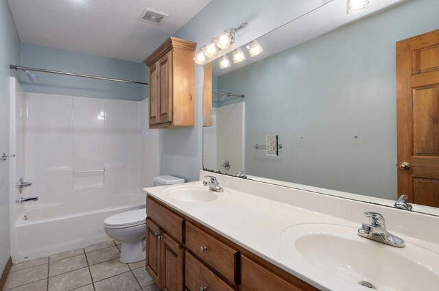 full bathroom featuring toilet, tile patterned floors, visible vents, and a sink