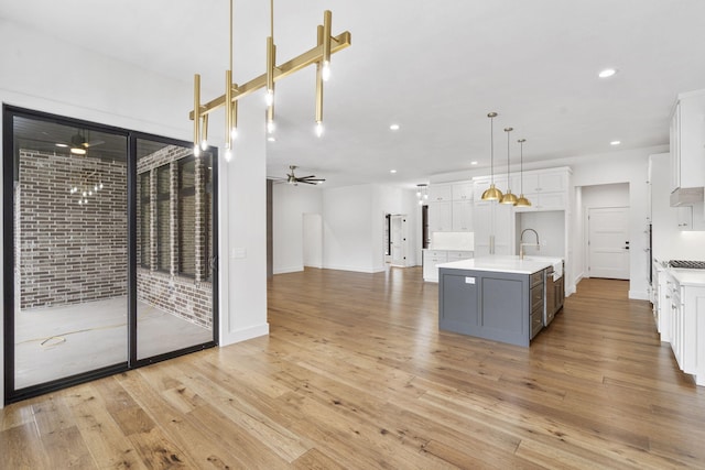 kitchen featuring recessed lighting, light countertops, white cabinetry, and ceiling fan