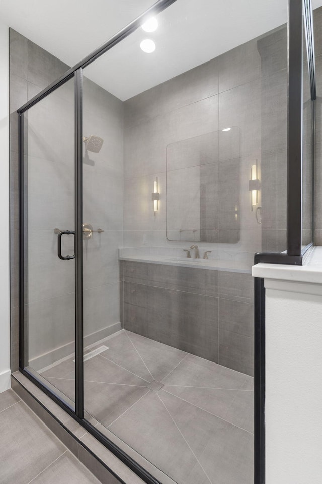 bathroom featuring tile patterned flooring and a shower stall