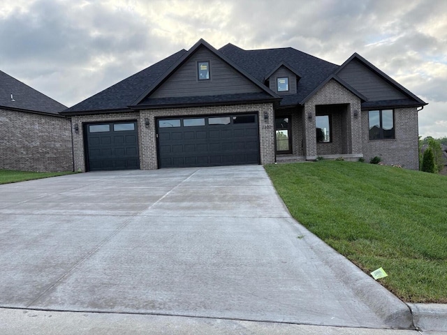 view of front facade with roof with shingles, brick siding, a garage, a front yard, and concrete driveway